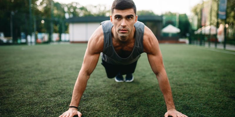 Athlete doing push-up exercise on outdoor workout