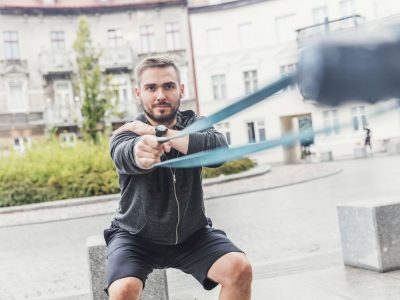 Man strengthening his arms in the city.