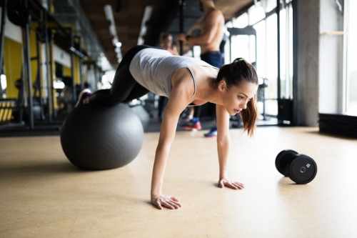 Athletic woman exercising in gym